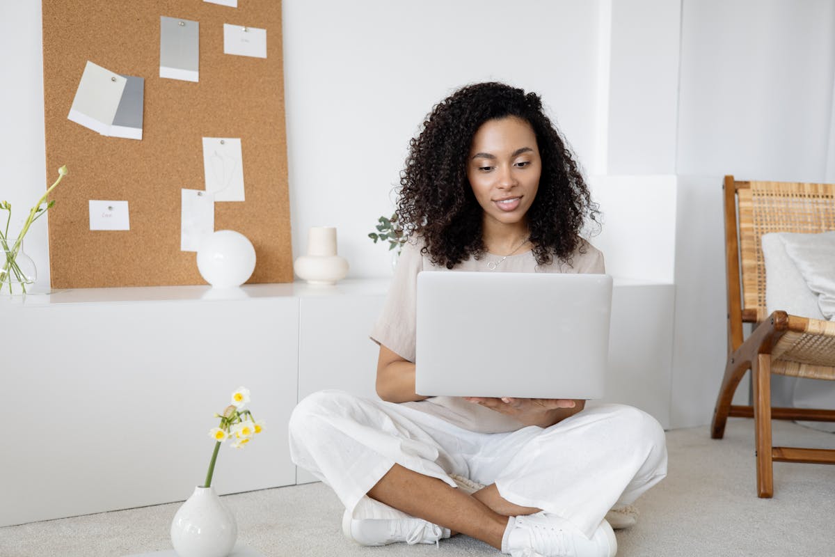Young professional woman studying on laptop, focused on learning and skill development